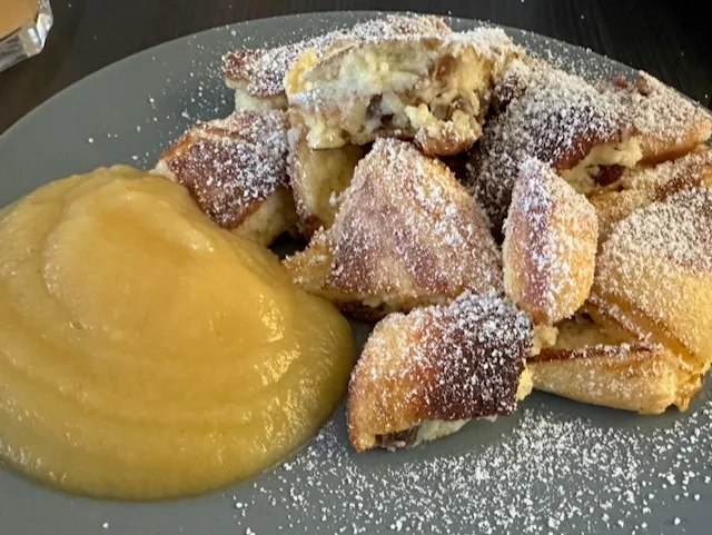 Kaiserschmarrn tearing in the pan with caramelized edges.